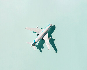 White plastic airplane on the blue background. Top view