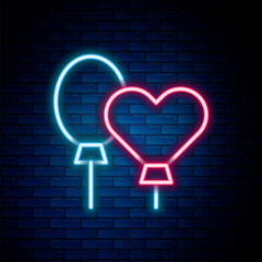 Glowing neon line Balloons with ribbon icon isolated on brick wall background. Colorful outline concept. Vector