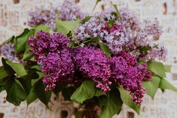 big delicate bouquet of lilacs in a vase on a beautiful background