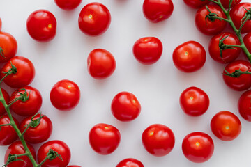 Top view of red cherry tomatoes on white background.