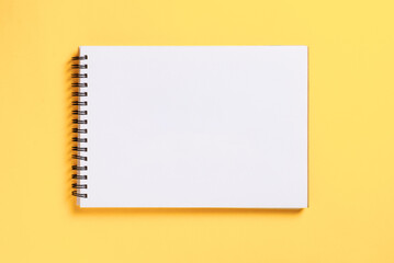 Notebook on yellow background