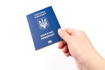 Passport of a citizen of Ukraine in a female hand on white background, close-up. Inscription in Ukrainian Ukraine Passport