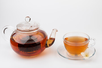 Composition with cup of jasmine tea and flowers on light background