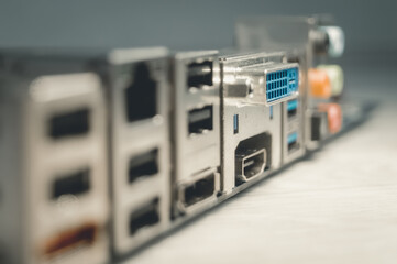 Blurred motherboard. HDMI, DVI, USB ports on the back of the computer motherboard to connect...