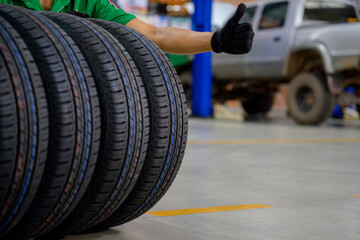 male tire changer In the process of checking the condition of new tires that are in stock to be replaced at a service center or auto repair shop Tire depot for the automobile industry