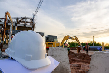 safety helmet or white hard hat construction engineer The background is blurry at the construction...
