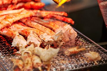 Grilled king crab legs displayed in a traditional market