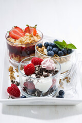 desserts with fresh berries in glasses, vertical