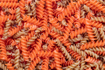 Whole, lentils fusilli pasta background.