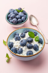 Cottage cheese with blueberry, fresh berries, keto healthy breakfast concept, top view.