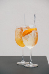 Two glasses of Spritz cocktail served on the terrace of urban bar. Popular Italian wine based beverage and summer aperitif refreshing drink.