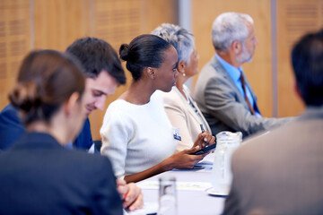 Getting the facts straight. A cropped shot of members of the press at a press conference.