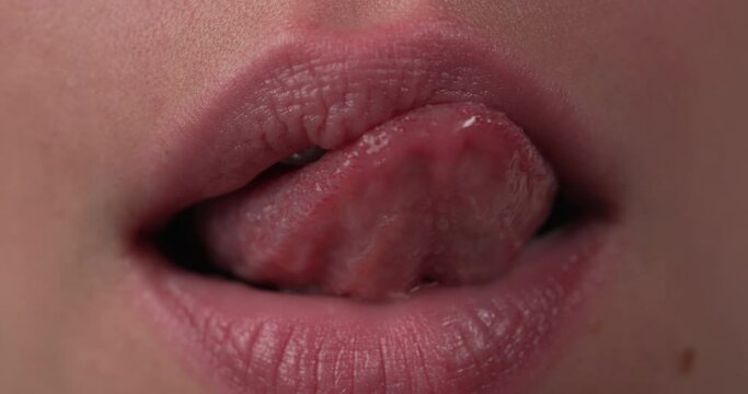 Close up of a white woman slowly licking her lips