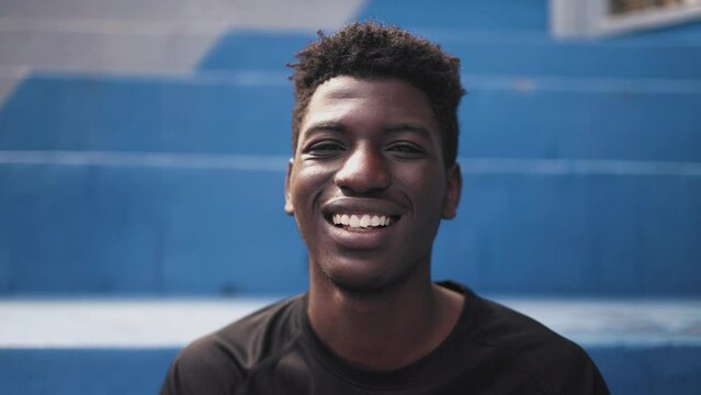 Happy young African teenager smiling in front of camera