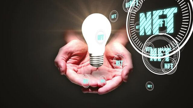 Animation of hand with light bulb and nft text over dark background