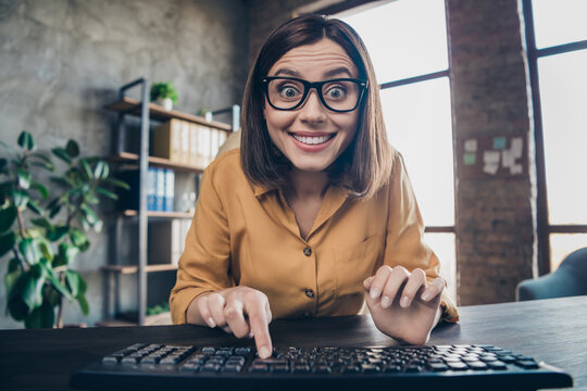Portrait of positive funny lady finger press keyboard look camera office building indoors
