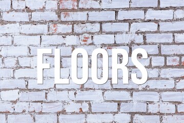 Fototapeta na wymiar FLOORS - word on concrete background. Cement floor, wall.