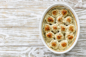 Baked Swedish meatballs in baking dish. Top view, copy space, flat lay.