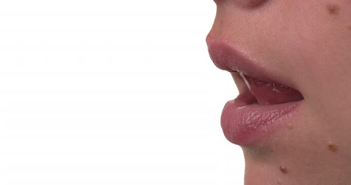 Close up side view of a caucasian woman licking her lips. Isolated on white background.