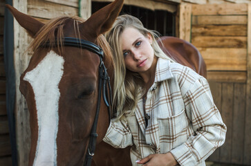 Young woman hugs her horse close-up on ranch. Pleasure, love and care for animals, nature country...