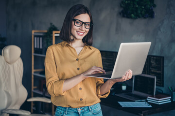 Portrait of attractive cheerful skilled girl expert editing project solving task issues at workplace workstation indoors