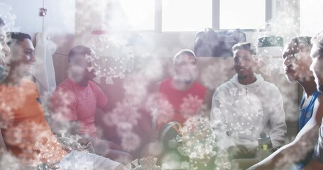 Animation of virus cells over diverse male rugby players talking in changing room - Powered by Adobe