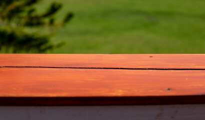 Top of wooden table and blurred nature background.