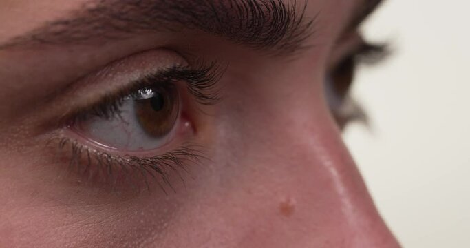 Close up side view of a white woman's eyes concentrating on something.