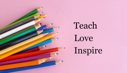 Teach ,love ,inspire text with colorful pencils on pink background 