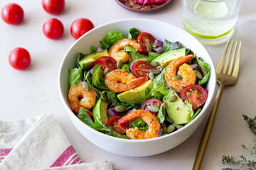 Salad with shrimps, avocado, tomatoes, onions and seeds. Healthy eating. Diet.