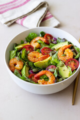 Salad with shrimps, avocado, tomatoes, onions and seeds. Healthy eating. Diet.