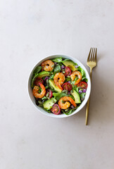 Salad with shrimps, avocado, tomatoes, onions and seeds. Healthy eating. Diet.