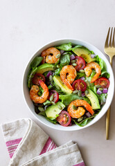 Salad with shrimps, avocado, tomatoes, onions and seeds. Healthy eating. Diet.