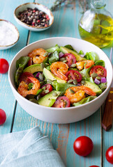 Salad with shrimps, avocado, tomatoes, onions and seeds. Healthy eating. Diet.