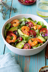 Salad with shrimps, avocado, tomatoes, onions and seeds. Healthy eating. Diet.