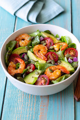 Salad with shrimps, avocado, tomatoes, onions and seeds. Healthy eating. Diet.