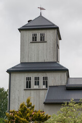 Durbe city firefighter building, tower. wooden building, metal roof, wind indicator. green trees,...