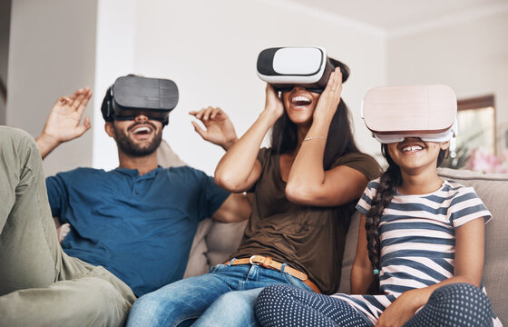 The future of family entertainment is here. Shot of a young family using virtual reality headsets together at home.