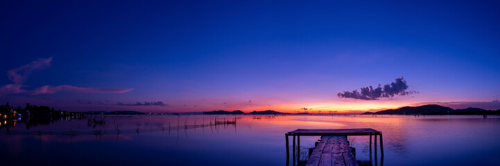 Fototapeta na wymiar Sunset over the lake HDR image. Landscape twilight sky on Songkhla lake.