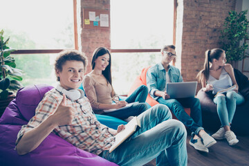 Photo of confident positive groupmates sitting dormitory preparing exams studying subjects indoors...