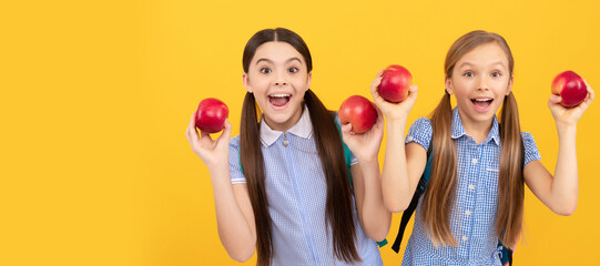 Fototapeta na wymiar Happy kids hold apples for healthy back to school snack yellow background, school feeding. Child girl portrait with apple, horizontal poster. Banner header with copy space.