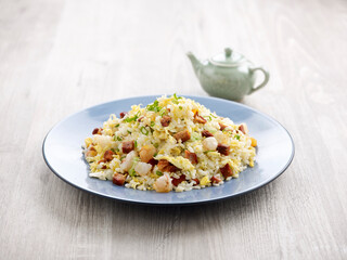 Yang Zhou Fried Rice with chopsticks served in a dish isolated on mat side view on grey background