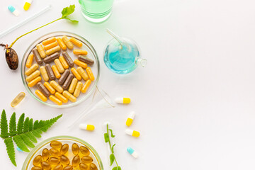 Test tubes with plants in a holder, vitamins on a light background, laboratory