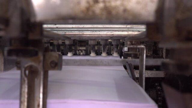 Books are being printed through machines.
