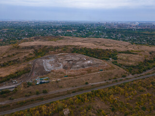 The concept of consumption and pollution. A lot of waste is thrown away. Aerial view and top view. City of Krivoy Rog, Ukraine. Huge garbage dump