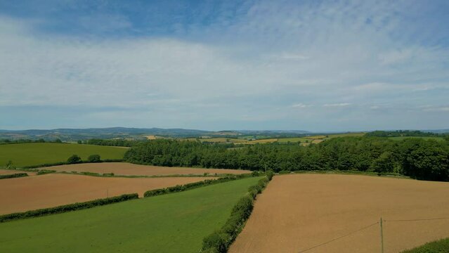 Ascending over rural agricultural fields in Devon