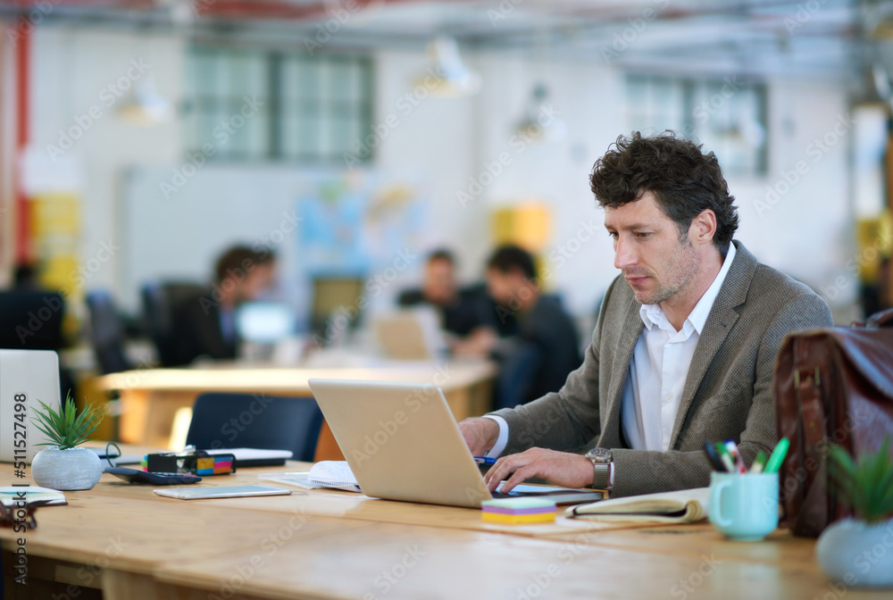 Poster If technology was a language, Id be fluent. Shot of a man working on a laptop in a large office.