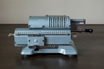 An old mechanical calculator on an old office desk.
