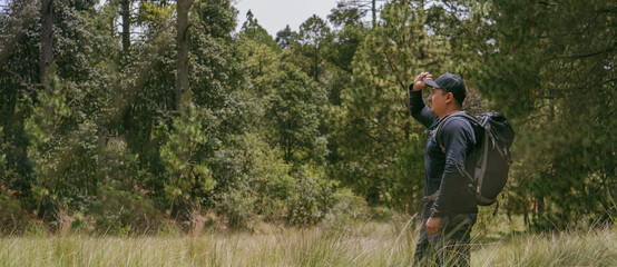 Fototapeta na wymiar Hiking - man hiker looking in nature
