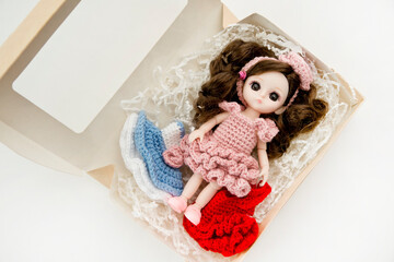 Fototapeta premium Baby girl cute doll with colorful hand crocheted knitting dress.